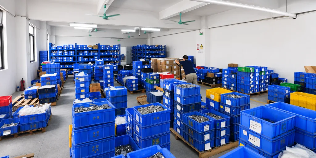 Finished hinge components stored in bins at an industrial hinge production warehouse