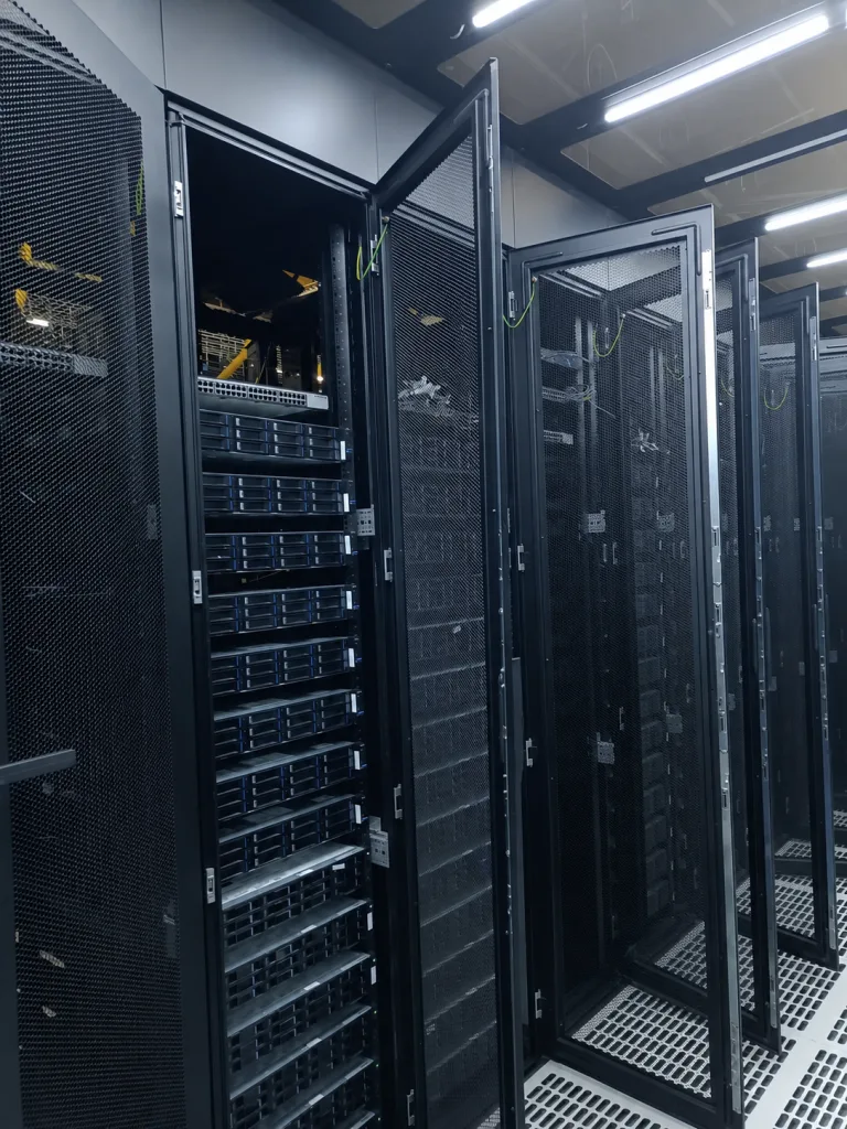 Open server rack doors in a narrow data center aisle