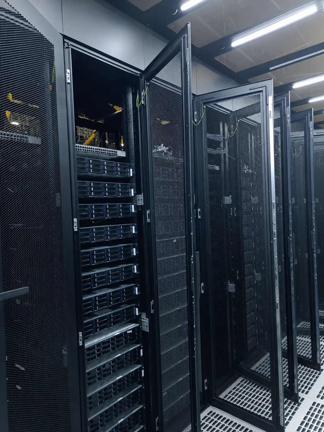 Open rack doors in a narrow equipment aisle