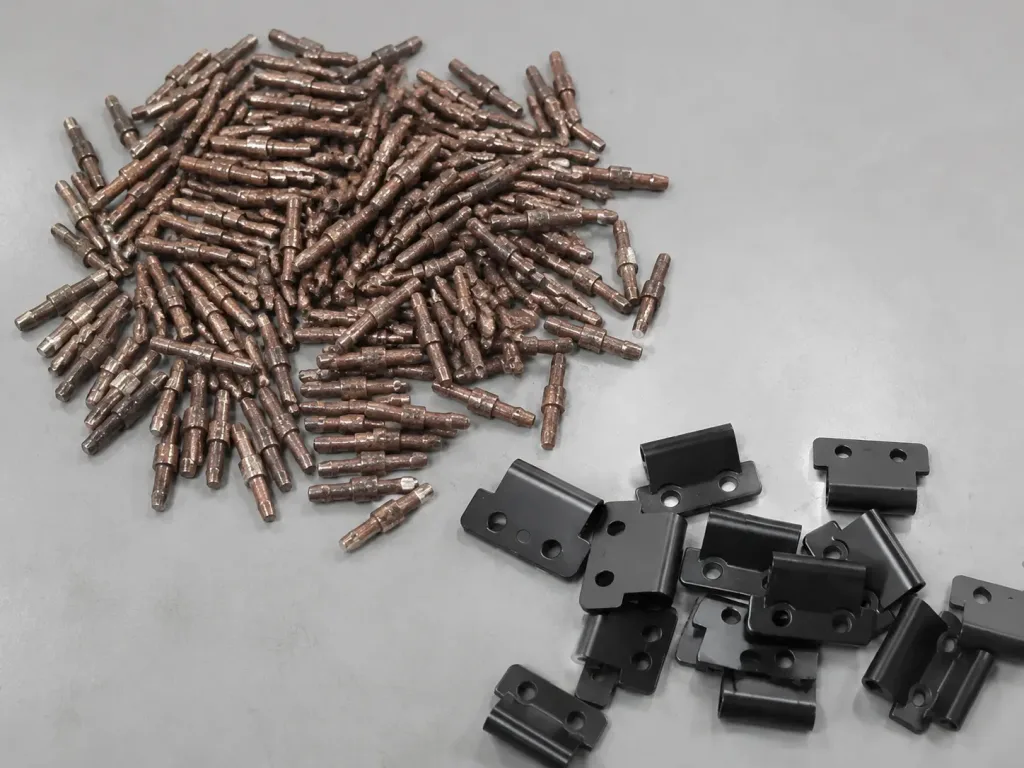 Hinge pins and hinge components during production