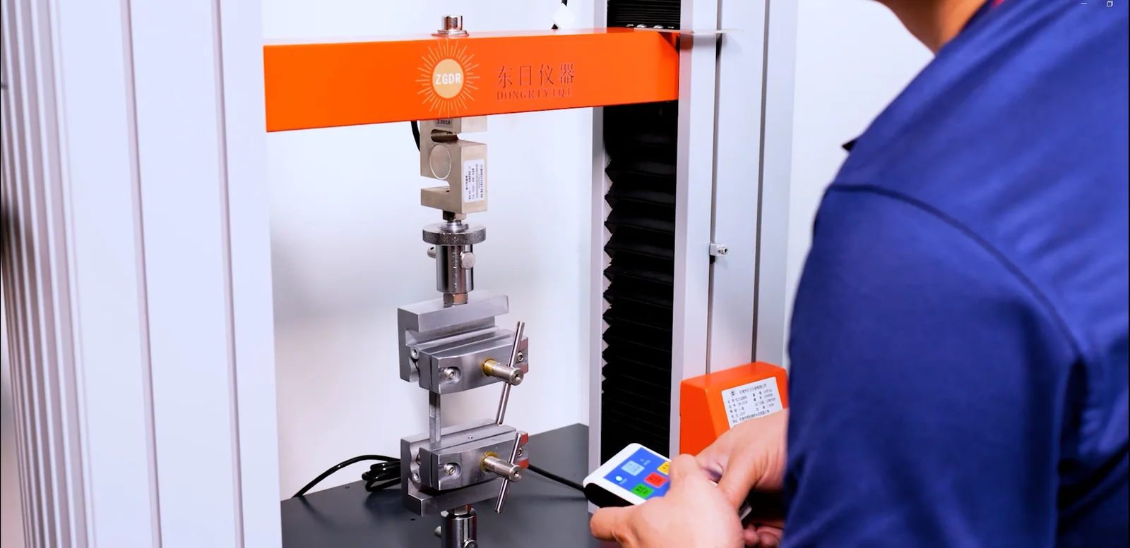 HSP technician operating load and tensile testing equipment for hinge validation